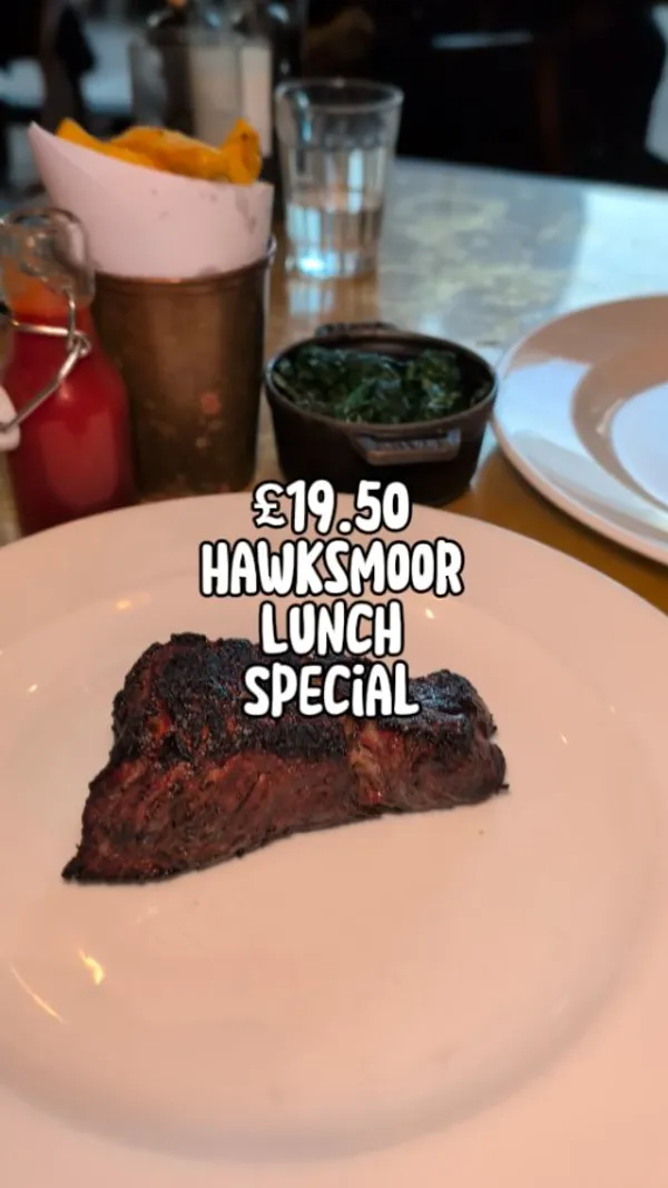 The video showcases a Hawksmoor restaurant in Canary Wharf, London.  It features a January lunch special: a 250g dry-aged, grass-fed rump steak for £19.50, which comes with one side. The video highlights the steak, beef dripping chips, spinach, a sticky toffee pudding, and a peanut butter shortbread.  The presentation is visually appealing, with attention given to plating and close-up shots of food textures. No specific dietary information is explicitly mentioned.