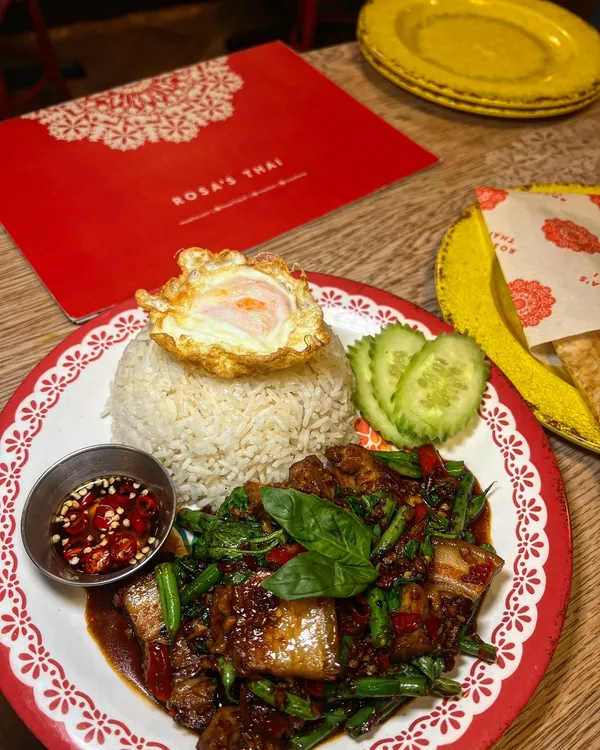 🌶️🌶️🌶️ @rosasthai is HOT RIGHT NOW

And they TRIPLE THREAT YOU! 
So if you are a spicy food lover, like I am! Head to one of their branches. And order from their menu any dish that displays 🌶️🌶️🌶️ and they will reward you with a FREE Iced Tea for your courage. (Until the 16th of February)

*Dishes are:

🍛 Green Curry
🍜 Drunken Noodles 
🍚 Chilli Basil Stir Fry ( Pad Kra Prow)
🥗 Papaya Salad.

*Complementary drinks:

1. Nam Manao (Thai lemonade)
2. Thai iced tea range
3. Pandan Iced tea

*What we order:

🦐 Tod Mun Goong (Prawn Doughnuts). 
Crispy prawn doughnuts, with egg, coriander and garlic, coated in panko breadcrumbs.Served with sticky plum sauce.

🦑 Plamuek Tod (Thai Calamari)
Seasoned with tom yum spices. Served with sweet chilli sauce. 

🍛 Gaeng Kiew Wan (Green Curry)
Thick, creamy and not for the faint-hearted. You can choose from different options, I went for the Slow-cooked Beef cheek.

🍜 Guaytiew Pad Kee Mao (Drunken Noodles)
Thai basil, krachai & fresh chillies. Choice of King Prawns.

 🍆 Pad Makhuea (Stir-fried aubergine)
Aubergine slices in light egg batter hit the wok with yellow bean sauce, chilli, soy and Thai basil.

🍳 Pad Kra Prow (Chilli & Basil Stir Fry)
Thai holy basil, fresh chillies, and green beans in stir-fry sauce.
Served just like in Thailand with jasmine rice, a crispy fried egg and prik nam pla dip on the side.
Choice of Pork Belly.
🫓 Roti Bread.

Lovely meal, lots of food! It would have come to around £80 altogether. We were 2 people, and we took food home, as it was plenty. 

Love the fragrant and spicy flavours! Definitely some dishes not for the faint hearted. 
From the 🌶️🌶️🌶️ I loved the green curry, the beef was sooo tender too. Flavours and spice level on point. And also the Pad Kra Prow, iconic!

From the non spicy or less, the prawn donuts and the aubergines stole my heart. 

Those Iced tea were the perfect cooling down formula. 

💫 Thanks for being great and hot🔥 

*Invite via @joli_app 

#spicyfood #🌶🌶🌶 #thaifood #thairestaurant