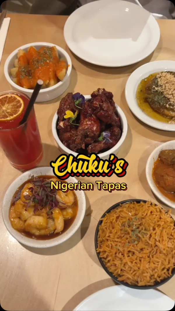 The video showcases Chuku's Nigerian Tapas restaurant in London. It features various dishes, including meatballs in a rich tomato sauce, flavorful fried chicken wings adorned with edible flowers, seasoned rice, succulent shrimp in a savory sauce, and plantain-like chips with a spicy dip.  A decadent yam brownie with ice cream is also highlighted. The drinks include a vibrant red beverage. The presentation emphasizes colorful plating and close-ups of the food's texture and detail.  The video primarily showcases a meal at the restaurant, highlighting both the food and the ambience.