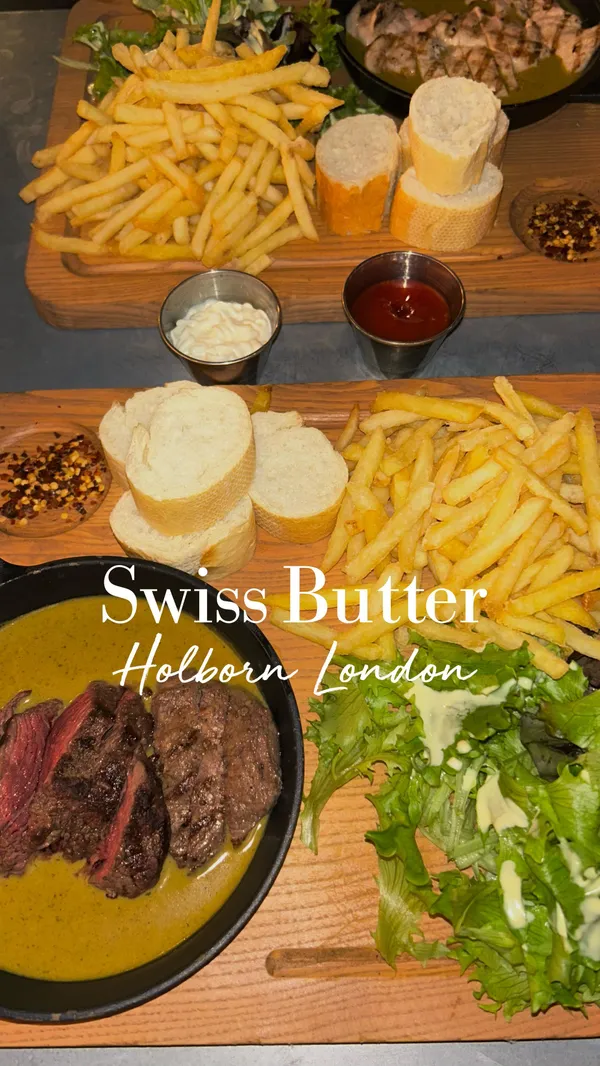 The video showcases Swiss Butter, a London restaurant. It features two main dishes: beef and chicken, both served with fries, salad, and baguette. The dishes are presented on wooden platters. The video emphasizes the restaurant's signature sauce. No specific dietary information is provided. The main focus is a meal showcase.