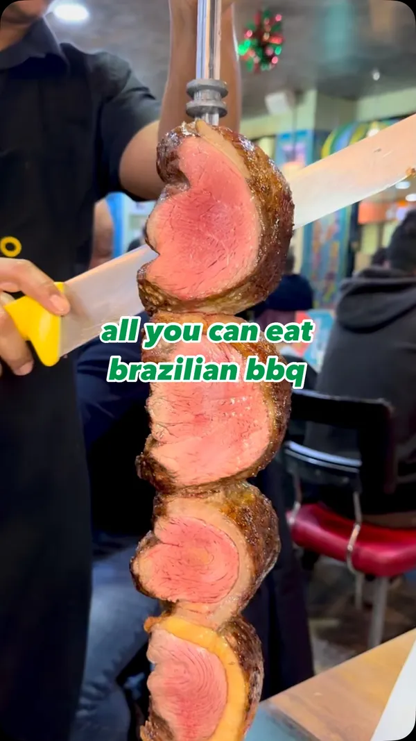 The video showcases Preto, a Brazilian BBQ restaurant. It features various cuts of meat (picanha, pork, chicken) being carved tableside. The buffet includes various vegetables, fries, and carbs. A chocolate fudge flan is also shown. The video highlights the restaurant's all-you-can-eat concept and the meat's juiciness.