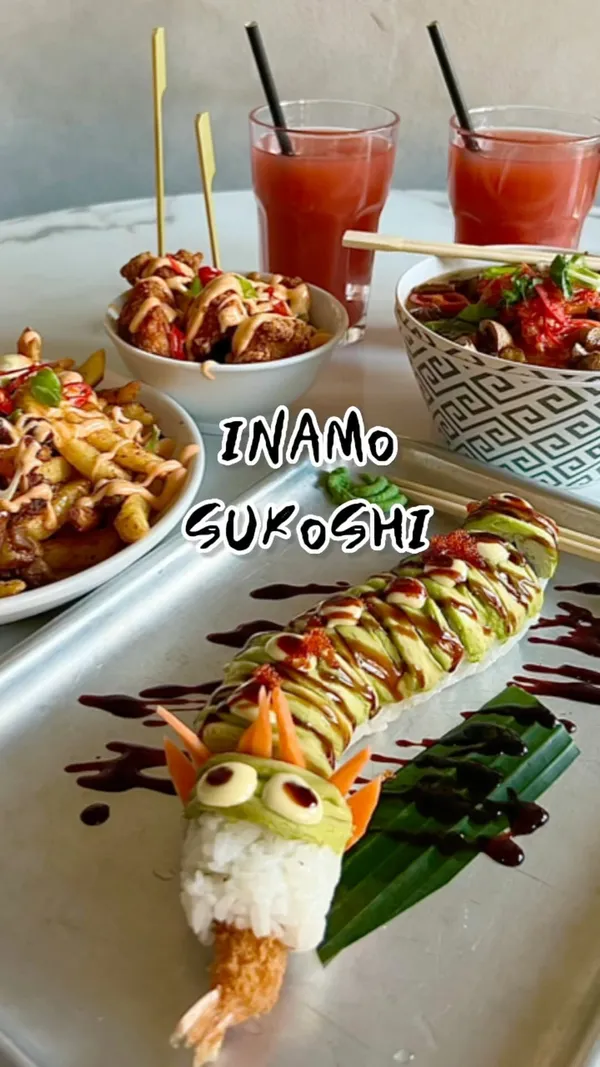 The video showcases Japanese fusion street food from Inamo, located in Market Halls Oxford Street, London. The food includes duck and mushroom ramen, a dragon roll, fried chicken karaage, and dirty duck fries. The presentation is visually appealing, with colorful dishes and close-up shots highlighting textures and details. No specific dietary information is provided. The main focus is on presenting the various dishes and creating a positive, appetizing vibe.