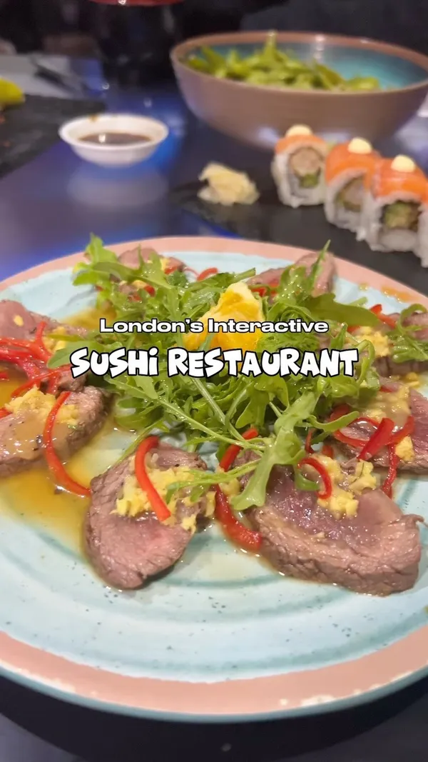 The video showcases Inamo restaurant in London, highlighting its interactive table features.  Various sushi dishes are shown, including a dragon roll, salmon rolls, and a beef dish. The presentation is modern and sleek, with food served on dark slate plates. The main focus is on the interactive dining experience and arcade games integrated into the tables.  No specific dietary information is provided.