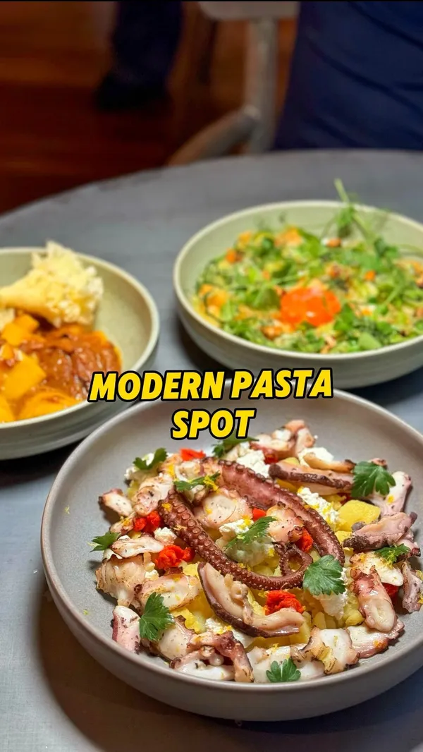 This video showcases a meal at NOCI, a modern pasta restaurant in Shoreditch, London.  The video presents a variety of dishes including focaccia, arancini, beef carpaccio, several pasta dishes (veal and pork ragu, silk handkerchiefs), seared octopus, and a chocolate mousse. The presentation focuses on visually appealing close-ups and overhead shots of each dish.