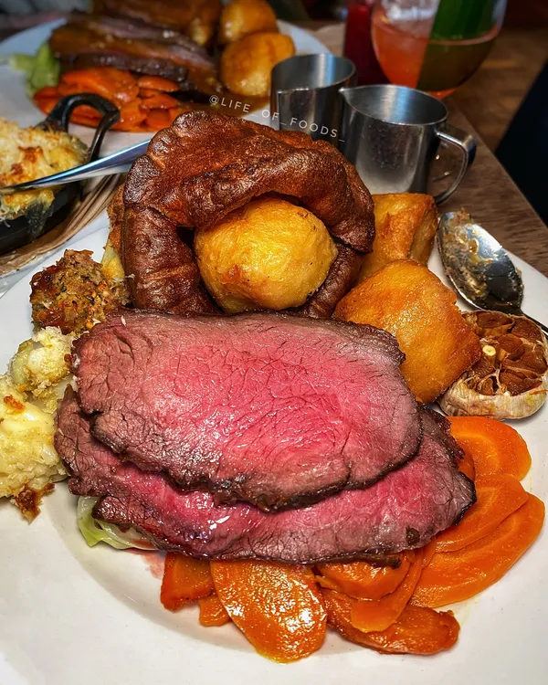 💫 London’s ICONIC Sunday Roast

🥇This London restaurant needs no introduction.. from amazing steaks to cosy dining vibes, @hawksmoorrestaurants Roasts have been voted as the Best Sunday Lunch in UK!

🥩 Their Sunday Roast comes with rump of 35-day dry-aged beef, which is slow cooked first on charcoal and finished in the oven. 🥔 It’s served alongside your typical trimmings like crispy beef dripping potatoes, 🥬 buttered greens & carrots, massive Yorkshire puddings, 🦴 and UNLIMITED bone marrow GRAVY

👉👉FOLLOW @life_of_foods_ for more!👈👈

🍽️ HAWKSMOOR
💰 £28pp for Beef Roast Dinner
👥 great for family & friend meet-ups, groups
📍 Various branches, but I went to the Borough branch - 16 Winchester Walk, London SE1 9AQ

*INVITE

We also had:
- Hawksmoor Stuffing £7
- Cauliflower Cheese £7
- Tropicano £12.5
- Virgin Forest £9.5
- Salted Caramel Rolos £6
- Blue Cheese £4

Review: I really enjoyed my Tropicano c0cktail to start.🥭 It had Mango v0dka & soda, which was interesting! For the roast, the beef was beautifully pink, tender too. 🥩 The yorkshires were massive, and although nice, some parts were too overdone (bit burnt) to eat. 🥕 The veggies and crunchy potatoes were also delicious with a generous portion. 🐮 The stuffing was awesome, would definitely get again (lovely flavour and soft), but I wasn’t too keen on the cauliflower. 🍫 I love their Choc rolos and have had them a few times (yes they make it themselves!)

🍖

#lifeoffoodsblog @joli_app #hawksmoor 

#londonsteak #londonrestaurant #londonfoodguide #londonrestaurantguide #toplondonrestaurants | london food restaurant | #wheretoeatlondon #londonfoodblogger #londonfoodscene #sundayroasts #sundayroastdinner #londonfoodies