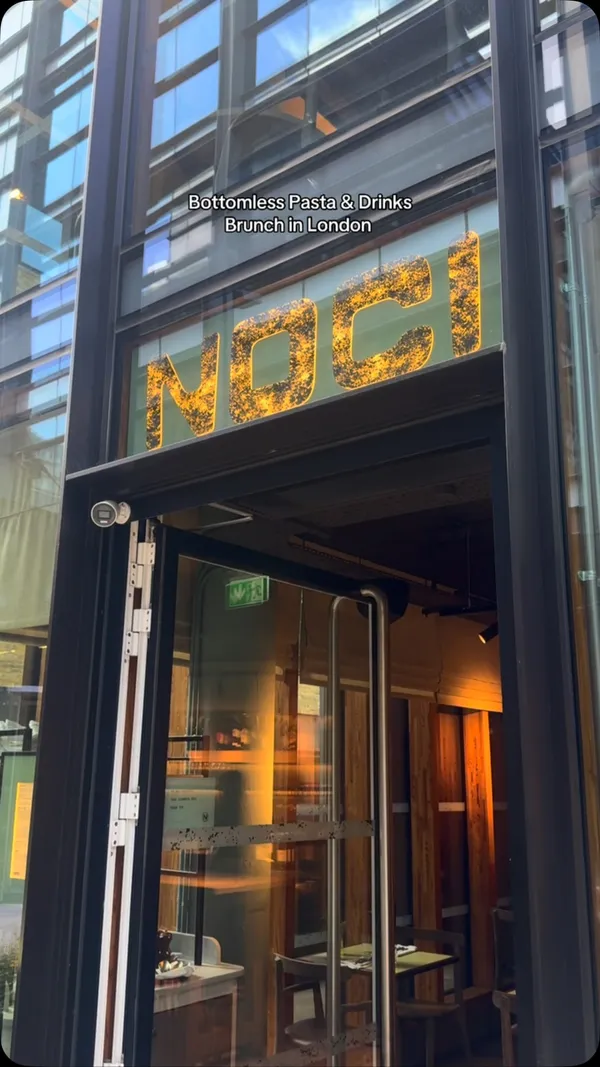 The video promotes a bottomless pasta and drinks brunch at Noci, a restaurant in London. It begins with exterior shots of the restaurant, then shows a group of friends toasting with Mango & Passionfruit Spritz. The food featured includes house focaccia with olive oil and balsamic vinegar, followed by four different pasta dishes: a cacio e pepe, a strozzapreti with courgettes, an amatriciana, and a beef ragu pappardelle. The video also showcases other drinks like the Sunset Sarti Spritz and Aperol Spritz. The overall focus is on the variety and appeal of the food and drinks offered in the brunch deal.