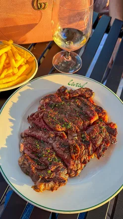 Exterior of a modern European restaurant at Westbourne Park, with outdoor seating and vibrant ambiance.