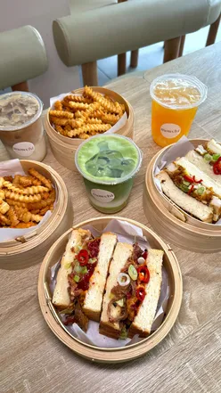 diners enjoying East Asian-inspired dishes and bubble tea at Mowchi café in Bradford, featuring desserts and cozy ambiance.