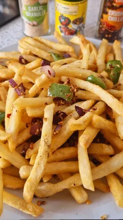 Plate of Chilli Garlic Chips served hot, perfect for sharing at a trendy Sheffield eatery.