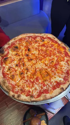 Group enjoying competitive games and cocktails at THE CUBE, Canary Wharf, a fun London activity for all!