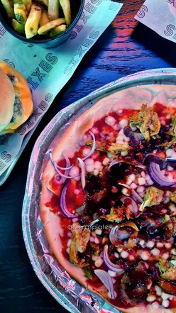 Friends enjoying cocktails and cricket at Sixes Social Cricket in Oxford, a unique interactive night out venue.