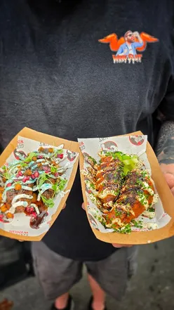 Participants enjoying wings and drinks at Wing Fest in Bristol, featuring diverse flavors from local vendors.