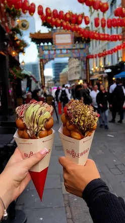 Indulging in vibrant bubble waffles with chocolate and strawberries at @bubblewraplondon in Chinatown, London.
