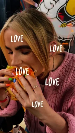 Burgers and miso wings showcased at Gurt Wings in Bristol, featuring flavorful tater tots and excited diners.