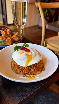 Delicious nasi goreng with an egg burst, served at Mangosteen Bristol's Gloucester Road branch.