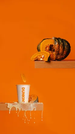 Creative autumn food photography with matcha, pumpkin spice drinks, and Dunkin’ doughnuts in bold colors and dynamic lighting.
