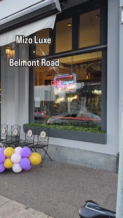 Excited diners enjoying Asian street food at Mizo Luxe Belfast on Belmont Road, with lively ambiance and enticing menu.