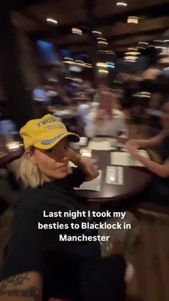 Friends enjoying delicious food and drinks at Black Lock Chops, smiling and having a great time.