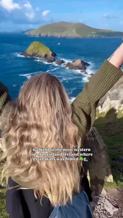 Stunning view from Dunmore Head overlooking Great Blasket Island, featuring rolling hills and the Atlantic Ocean.