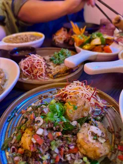 “Delicious spread of Thai dishes at Mangosteen Bristol's new Glous Road location, featuring spring rolls, pad Thai, and more.”