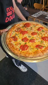 Delicious pizzas at the Pitfire Slice Bar pre-launch in Leicester, featuring unique flavors and halal options.