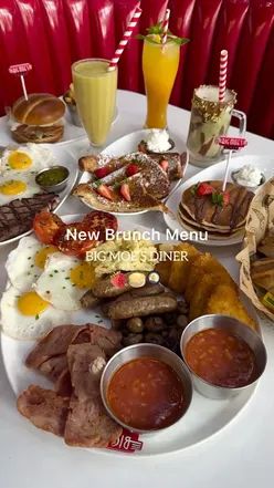 Brunch at Big Moe's Diner in Ilford featuring a hearty breakfast platter, burgers, steak & eggs, French toast, and pancakes.