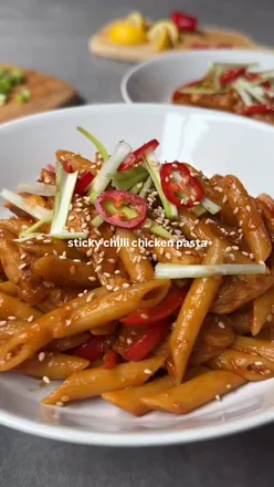 Delicious sticky chicken pasta served with spring onions and sesame seeds, inspired by Frankie and Benny’s recipe.