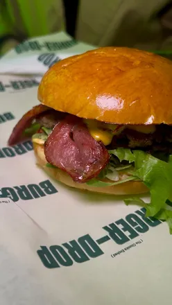 Delicious smash burgers and loaded fries from Burger Drop in Boro, featuring their signature sauce and meal deals.