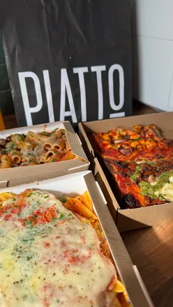 Group enjoying hearty Italian dishes like chicken parmigiana and pizza slices at Piatto 44 in Shawlands.