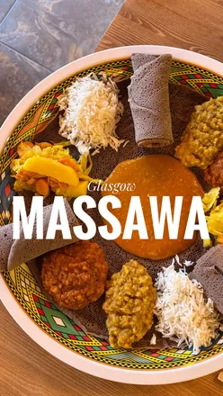 Enjoying a delicious meal at Massawa, Glasgow, featuring diverse options for all diets and a vibrant atmosphere.