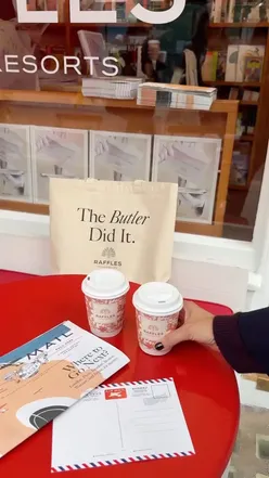 Visitors enjoying free coffee at the Raffles x Air Mail pop-up in Marylebone, featuring exclusive tote bags.