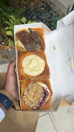 A tempting display of delicious brownies and doughnuts at a London dessert shop, perfect for food lovers.