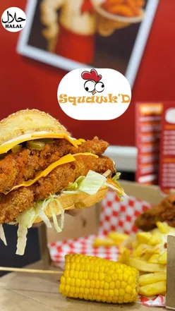 Delicious takeaway from Squawk on Aikenhead Road featuring a burger box, wings, corn tenders, and Cajun fries.