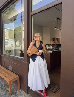 People enjoying a sunny Sunday gathering outdoors with food and drinks