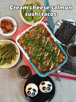 Delicious cream cheese salmon sushi tacos served with bao bun and fried asparagus, featuring fresh ingredients and vibrant colors.