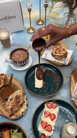 Enjoying the Dubai Paratha Burger and other treats at Swirldrop Treats' 3-year celebration event in Ilford.