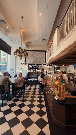 Enjoying PAUL's £5 Breakfast Deal with coffee and pastries in London’s Bankside café.