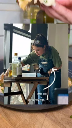 Rhi, a Manchester-based cook, sharing approachable plant-based recipes for all diets in a vibrant kitchen setting.