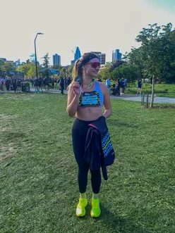 Runner celebrating a new PB at the Run Shoreditch 10K, supported by partner, with Saucony gear and race excitement.