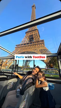 Tourists enjoying a hop-on hop-off bus experience in Paris, capturing major landmarks like the Eiffel Tower.