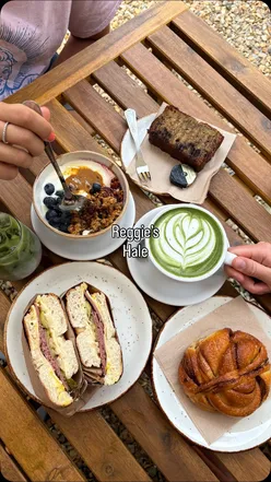 Customers enjoying coffee and bagels at Reggie’s Cafe in Hale, Greater Manchester.