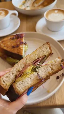 Minimalist cafe @kulcoffee_ in Edinburgh, serving excellent coffee and delicious Reuben sandwich in a stylish atmosphere.