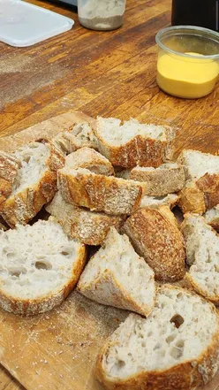 Participants learning to make sourdough at Bread Ahead Bakery's Sourdough Starter School in London.