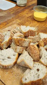 Participants learning to make sourdough at Bread Ahead Bakery's Sourdough Starter School in London.