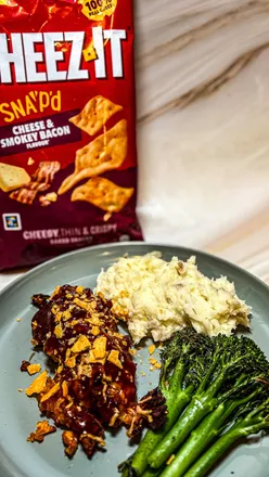 Close-up of Cheez-Its with cheese and smokey bacon, paired with Hunters Chicken dish for a tasty snack combination.