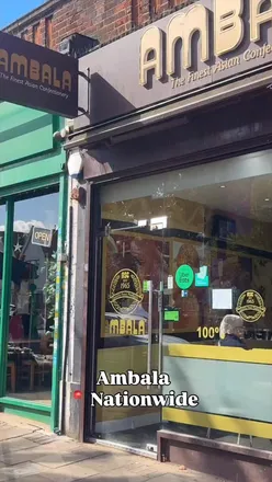 Customers enjoying festive Asian sweets at Ambala’s 60th birthday celebration in London.