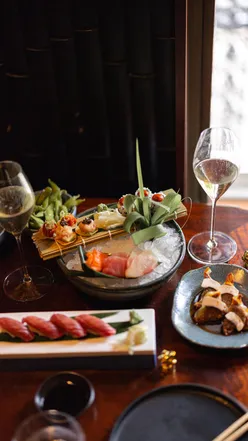 Brunch spread featuring sushi, bao buns, and golden chopstick rests at Lucky Cat by Gordon Ramsay in Mayfair.