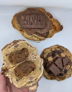 Delicious carrot cake stuffed cookie topped with a Malteser gingerbread bunny from @crumbs._bakes, showcasing dessert perfection.