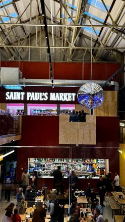 Patrons enjoying diverse cuisines at the grand opening of Saint Paul’s Market in Birmingham's Jewellery Quarter.