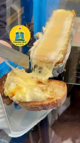 Cheese lovers enjoying raclette and Zapiekanka at The Cheese Box, an iconic old police box in Glasgow City Centre.